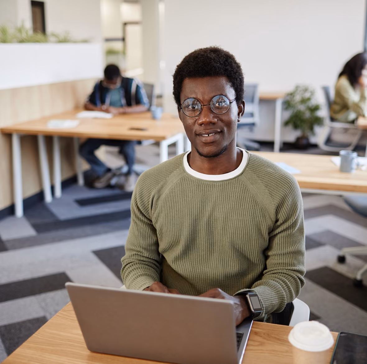 Consultant working on a laptop in a bright office
